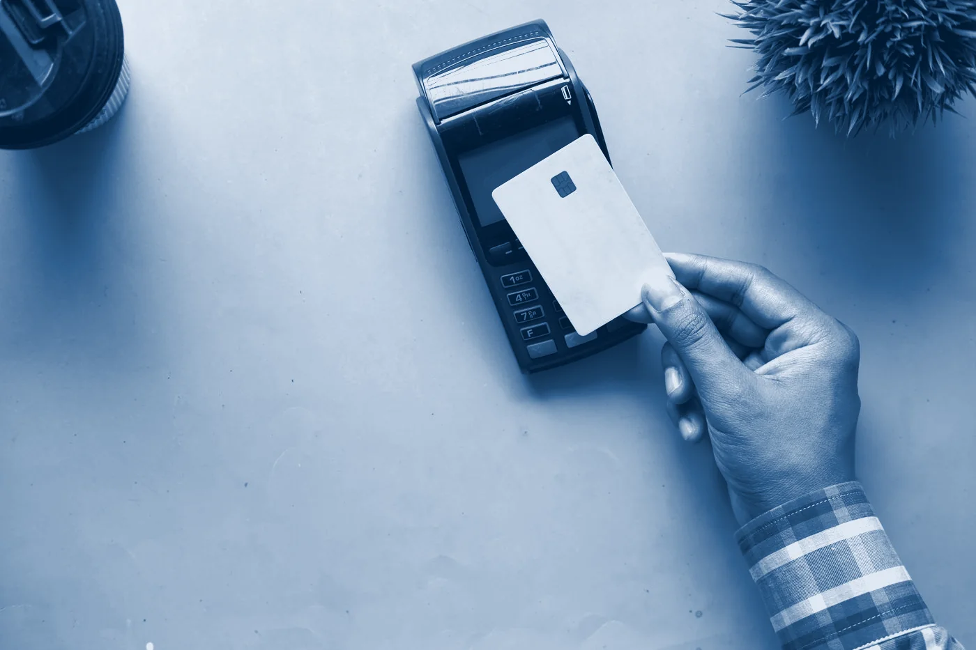 A card held over a payment terminal