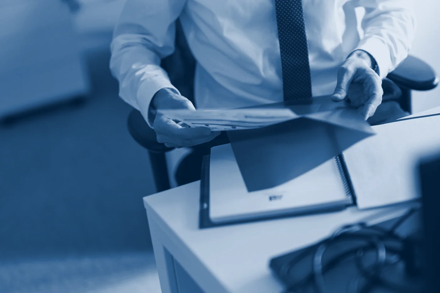 A consultant handing over a file