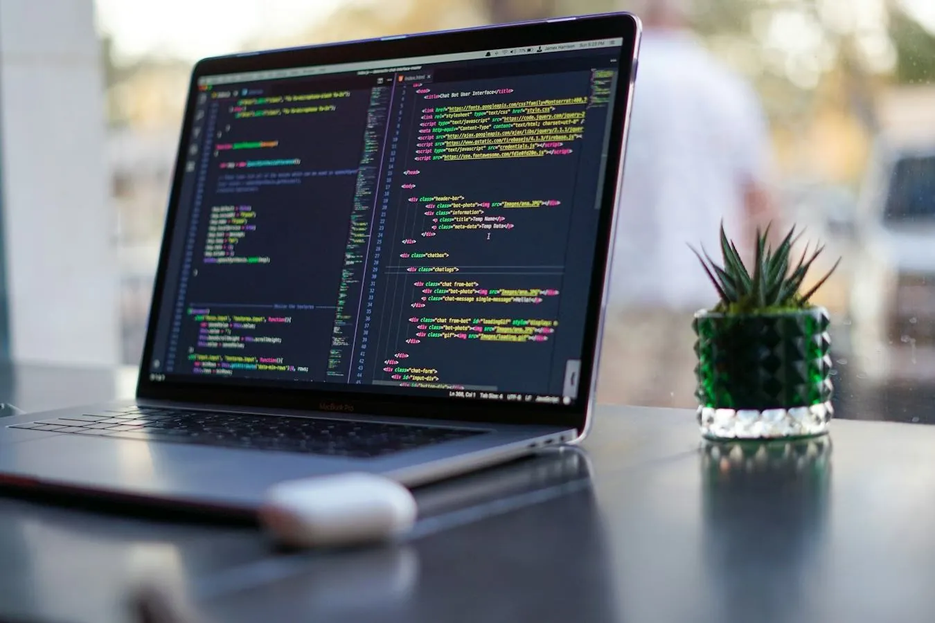 A laptop showing code on a desk